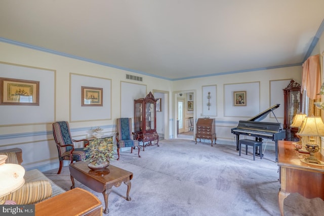 living room featuring a decorative wall, carpet, visible vents, and ornamental molding