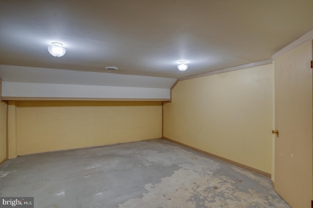 finished below grade area featuring concrete block wall