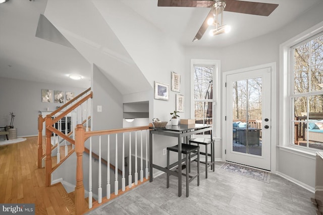 interior space with ceiling fan, light wood finished floors, and baseboards