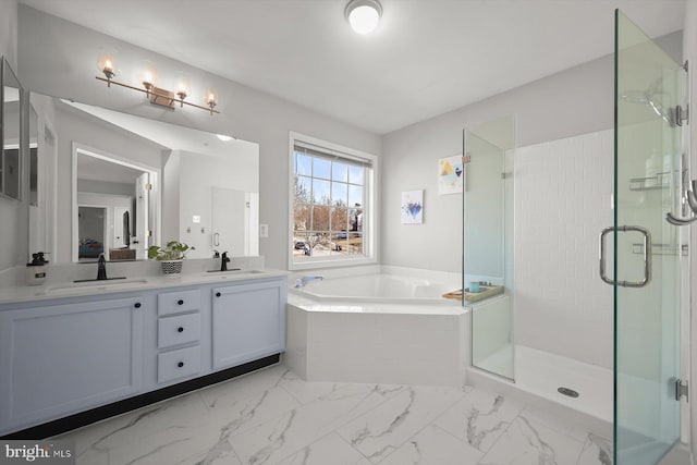 bathroom with marble finish floor, a sink, a bath, and a shower stall