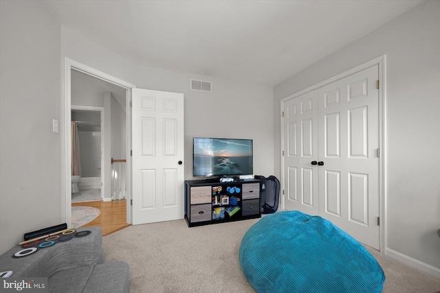 bedroom with carpet floors, a closet, and visible vents