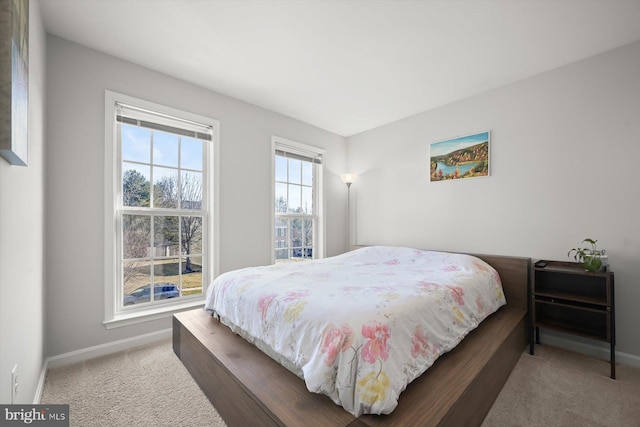 bedroom featuring carpet and baseboards