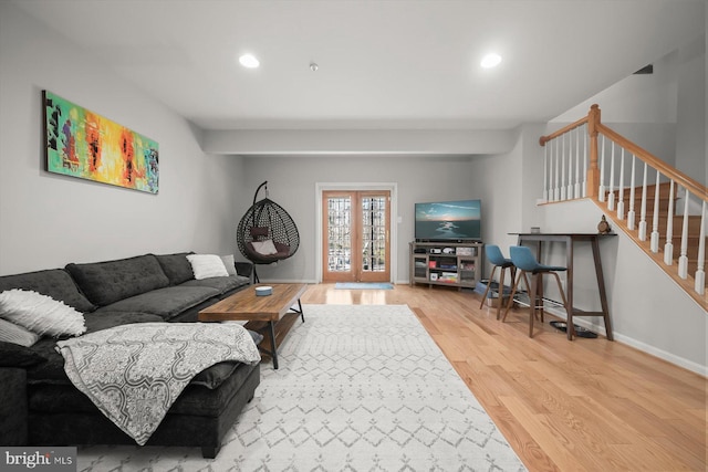 living room with french doors, recessed lighting, wood finished floors, baseboards, and stairs