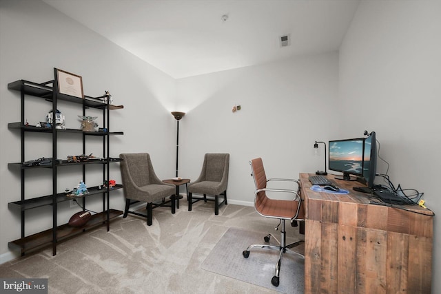 carpeted office space with baseboards and visible vents