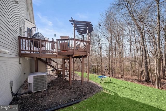 view of yard featuring central air condition unit, stairway, a playground, and a wooden deck