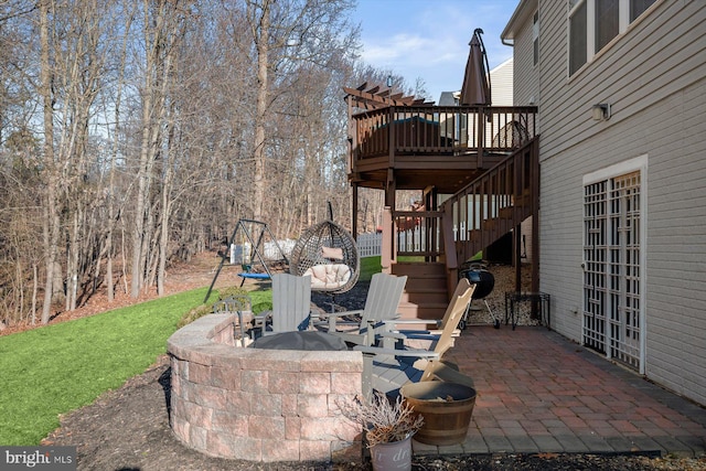 view of patio with an outdoor fire pit and stairway