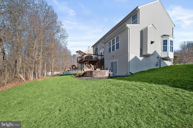 view of property exterior featuring a deck, brick siding, and a lawn