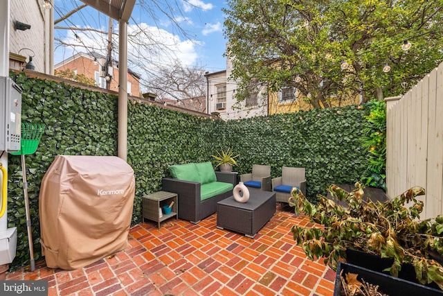 view of patio with an outdoor living space, a fenced backyard, and a grill