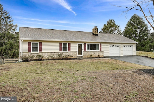 ranch-style home with aphalt driveway, a front yard, a chimney, and a garage