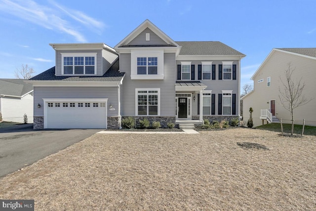 view of front of property featuring a garage, stone siding, and aphalt driveway