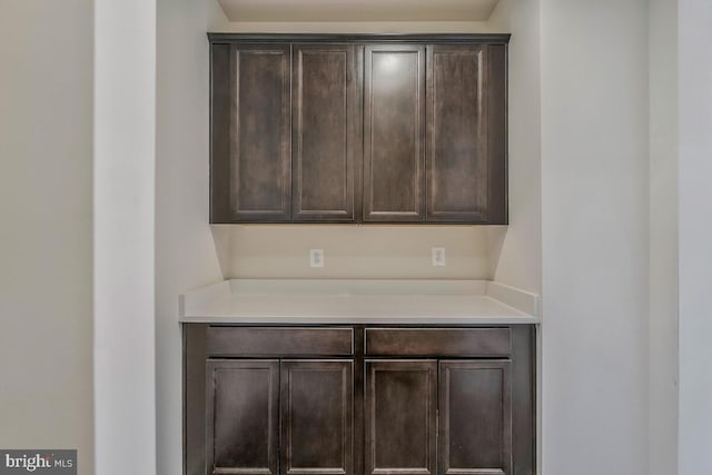 kitchen with light countertops and dark brown cabinets