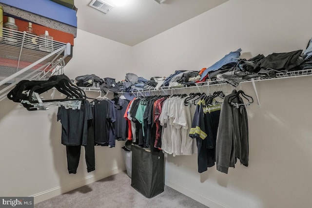 spacious closet with carpet floors and visible vents