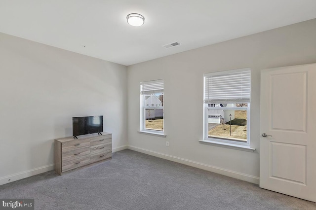 unfurnished bedroom featuring carpet flooring, visible vents, and baseboards