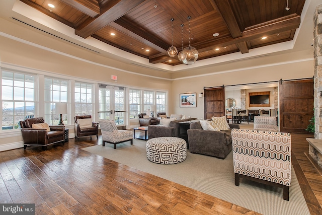 living room featuring a towering ceiling, a barn door, wood ceiling, coffered ceiling, and hardwood / wood-style floors