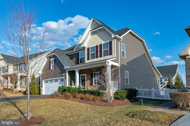 view of front of property featuring aphalt driveway, a porch, an attached garage, fence, and a front lawn