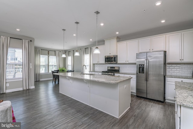 kitchen featuring stainless steel appliances, dark wood-type flooring, a sink, and white cabinetry