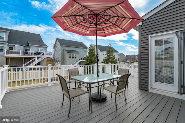 deck featuring a residential view and outdoor dining area