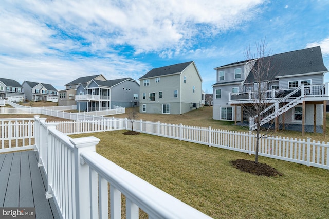 exterior space featuring a fenced backyard, a residential view, and a lawn