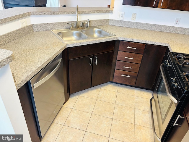 kitchen with light tile patterned floors, range with gas stovetop, dishwasher, light countertops, and a sink