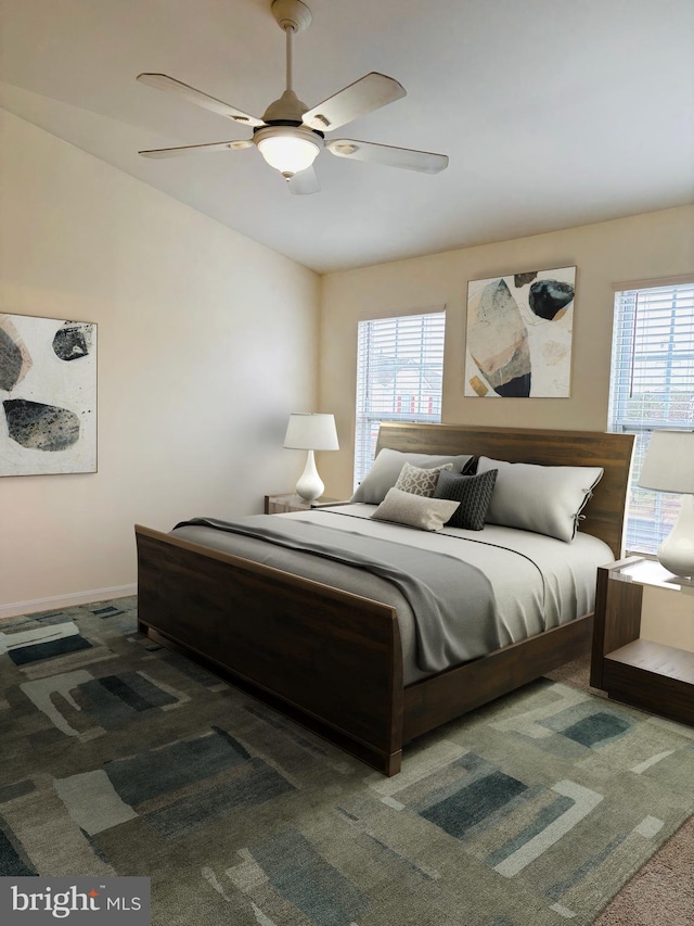 carpeted bedroom with lofted ceiling, multiple windows, ceiling fan, and baseboards