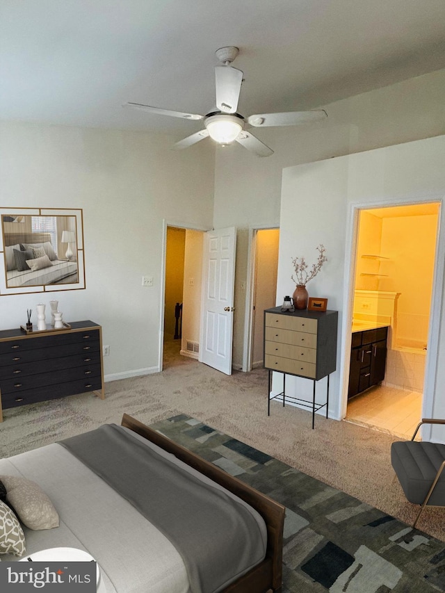 bedroom with visible vents, a ceiling fan, carpet flooring, ensuite bath, and baseboards