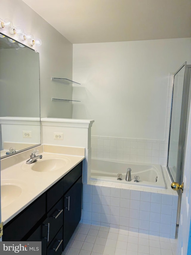 bathroom featuring a bath, tile patterned flooring, double vanity, and a sink