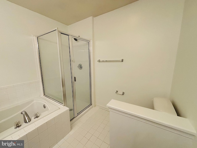 bathroom with toilet, a stall shower, a garden tub, and tile patterned floors