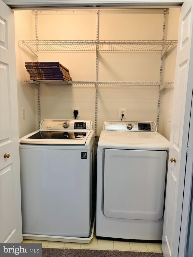 laundry room featuring laundry area, light tile patterned flooring, and independent washer and dryer