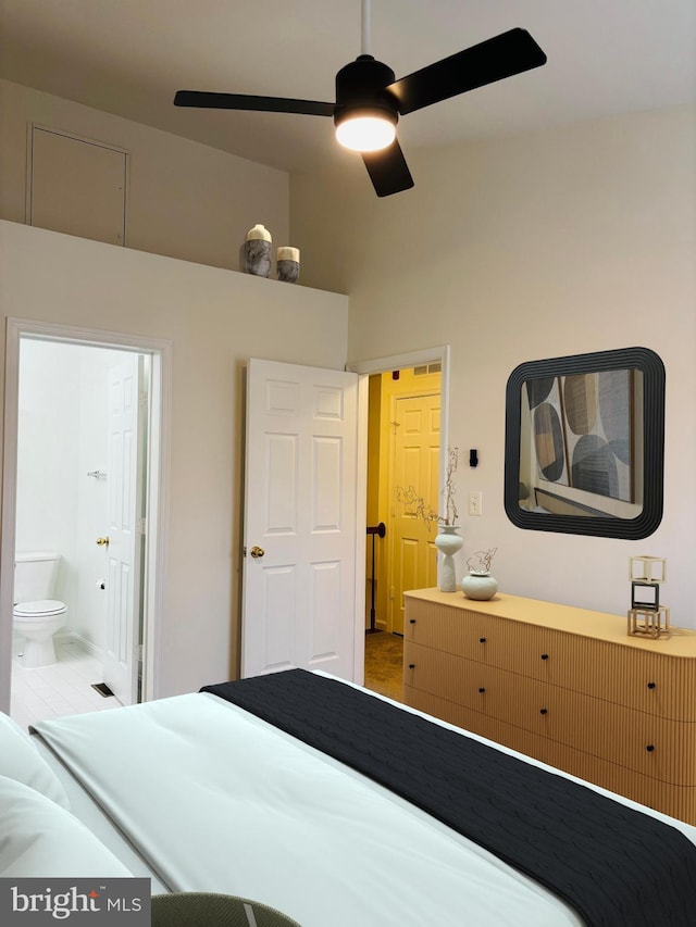 bedroom with ensuite bathroom and a ceiling fan