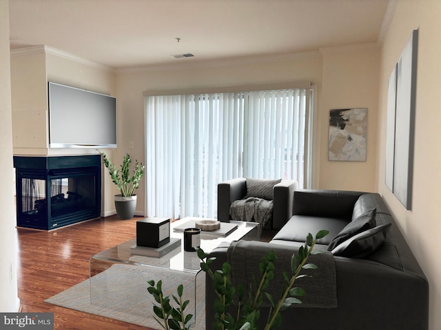 living room with visible vents, crown molding, a multi sided fireplace, and wood finished floors