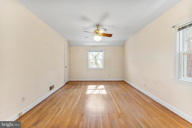 unfurnished room featuring visible vents, ceiling fan, light wood-style flooring, and baseboards