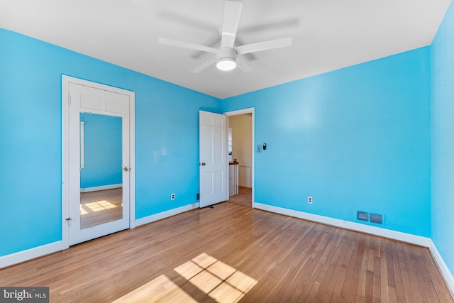 unfurnished bedroom with light wood-style flooring, visible vents, baseboards, and ceiling fan