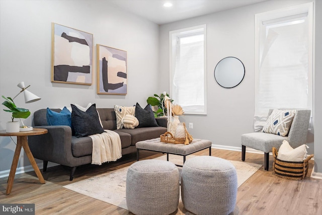 living area featuring recessed lighting, baseboards, and wood finished floors