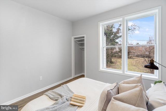 bedroom featuring baseboards and wood finished floors