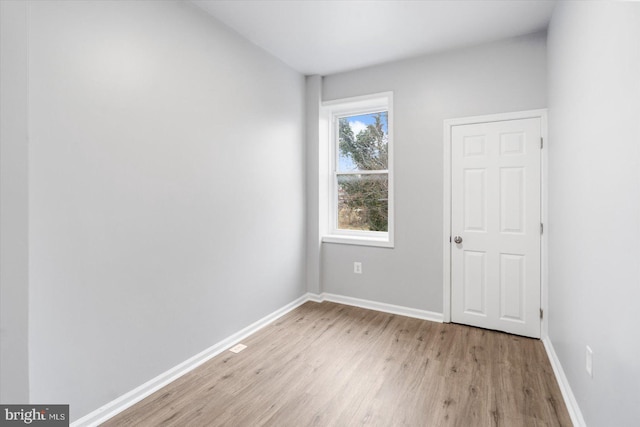 unfurnished room featuring light wood-type flooring and baseboards