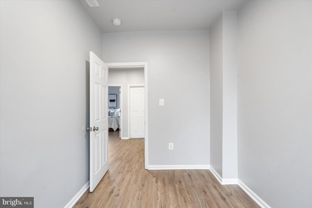 unfurnished room with baseboards and wood finished floors