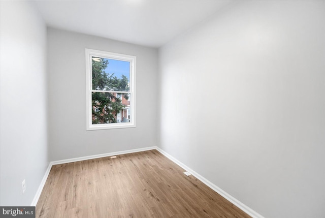 unfurnished room with wood finished floors and baseboards