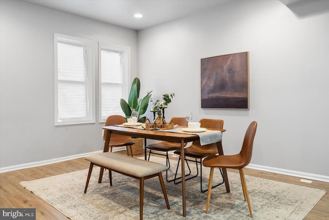 dining room featuring recessed lighting, baseboards, and wood finished floors