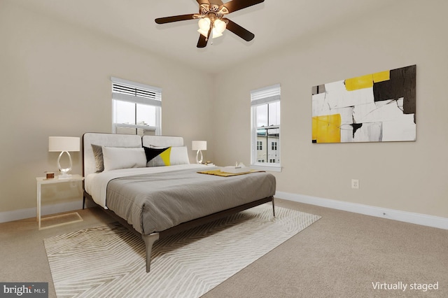 bedroom with a ceiling fan, carpet flooring, and baseboards