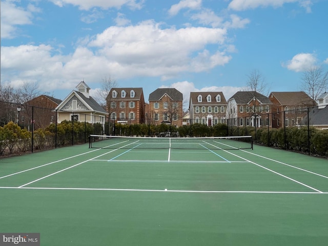 view of sport court featuring community basketball court, fence, and a residential view