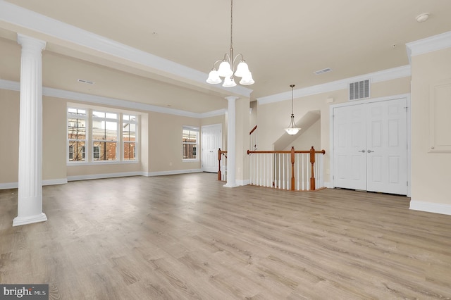 unfurnished living room featuring baseboards, light wood finished floors, visible vents, and ornate columns