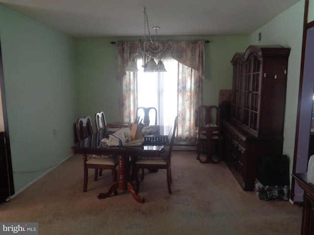 dining room featuring light carpet and a notable chandelier