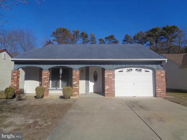 ranch-style house with a garage, roof with shingles, concrete driveway, and brick siding