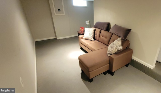 living room with finished concrete floors and baseboards