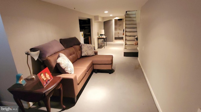 living room with stairs, recessed lighting, finished concrete flooring, and baseboards