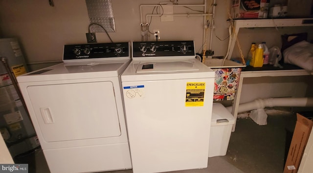 laundry room with washer and dryer, laundry area, and strapped water heater