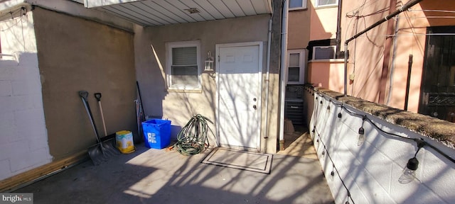 property entrance with stucco siding