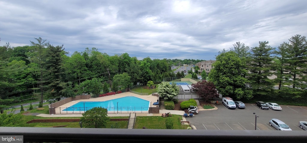 community pool featuring a patio and fence