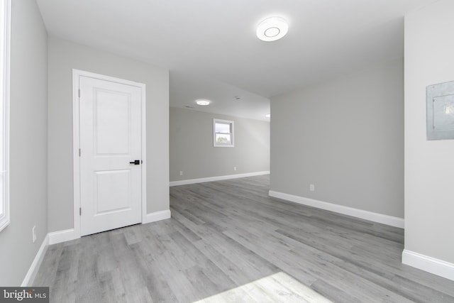 spare room featuring light wood-style flooring and baseboards