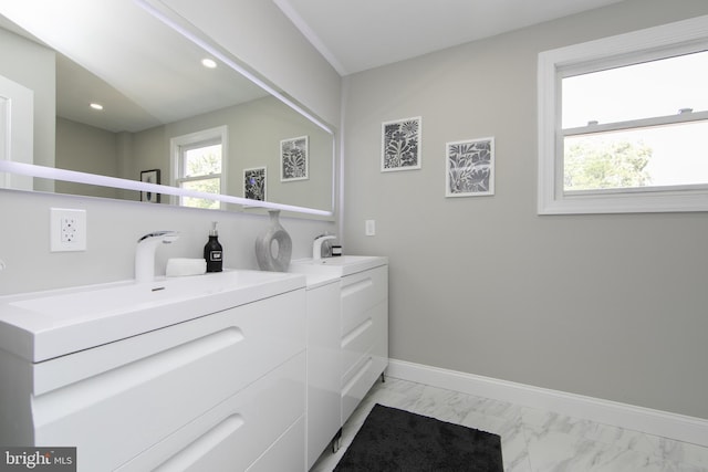 laundry room with laundry area, baseboards, marble finish floor, washer and dryer, and a healthy amount of sunlight